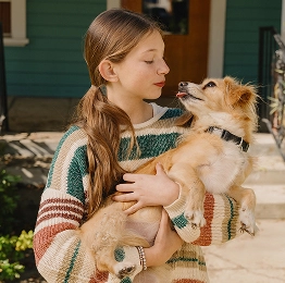 Girl holding small dog